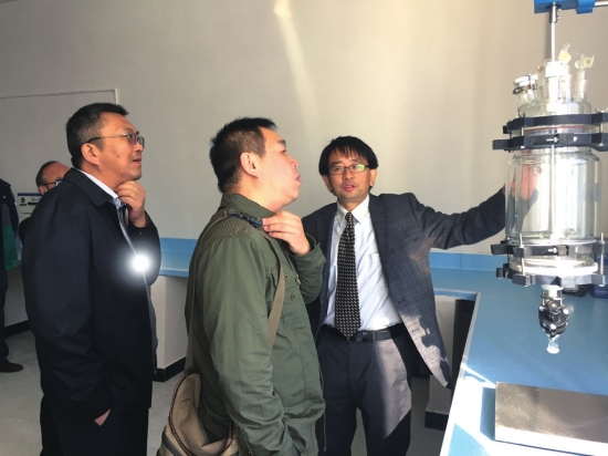  云南鐵坦新材料科技股份有限公司董事長王安之（右一），陪同各方專家參觀其實驗室并介紹精良設備。經報記者 何光明攝 